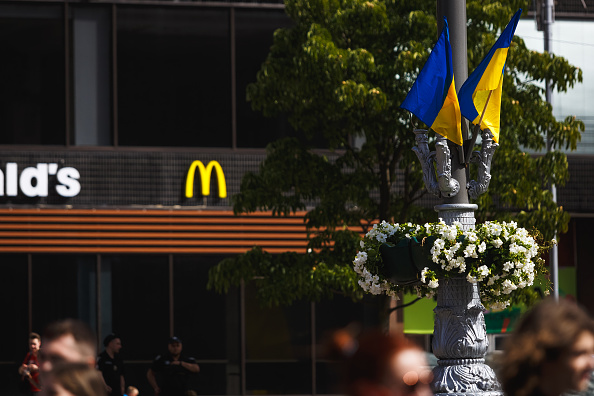 Golden arches. Blue-and-yellow flags. (Yurii Stefanyak/Getty Images)
