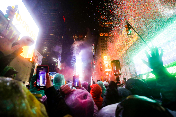 Waiting for the New Year’s ball drop [Jason Dean via Getty Images]